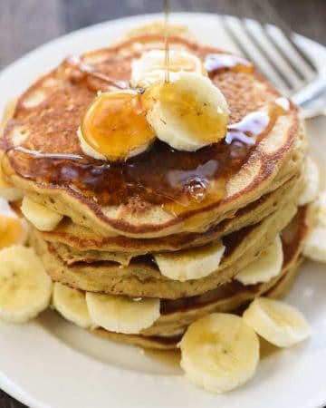 Perfect Whole Wheat Banana Pancakes ~ scrumptious and wholesome, these pancakes are light and fluffy with crisp, golden edges and delicious banana flavor. And nobody will ever guess that this amazing banana pancake recipe is made with 100% whole wheat flour! | FiveHeartHome.com