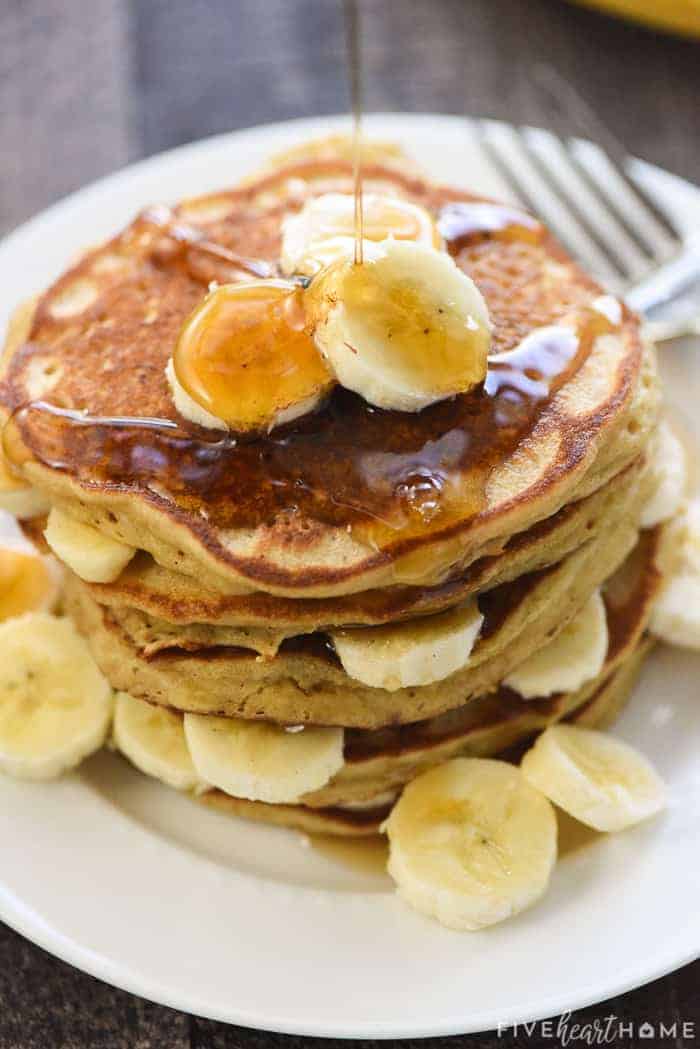 Perfect Whole Wheat Banana Pancakes ~ scrumptious and wholesome, these pancakes are light and fluffy with crisp, golden edges and delicious banana flavor. And nobody will ever guess that this amazing banana pancake recipe is made with 100% whole wheat flour! | FiveHeartHome.com