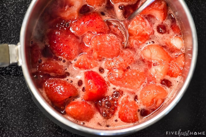 Strawberries cooking down in a pot for Chia Seed Jam.