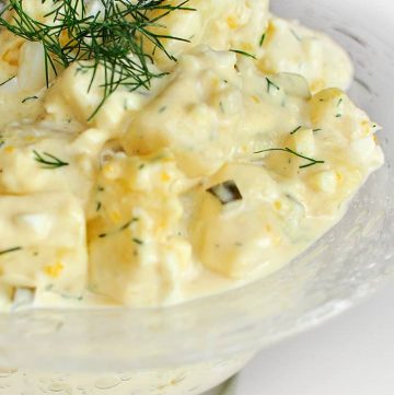 Classic Potato Salad -- featuring mayo, sour cream, mustard, pickles, hard-boiled eggs, and fresh dill -- is the perfect summer side dish! | FiveHeartHome.com