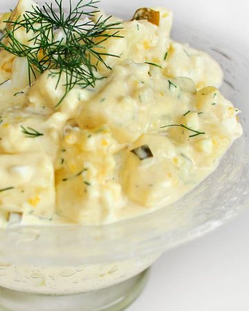 Classic Potato Salad -- featuring mayo, sour cream, mustard, pickles, hard-boiled eggs, and fresh dill -- is the perfect summer side dish! | FiveHeartHome.com