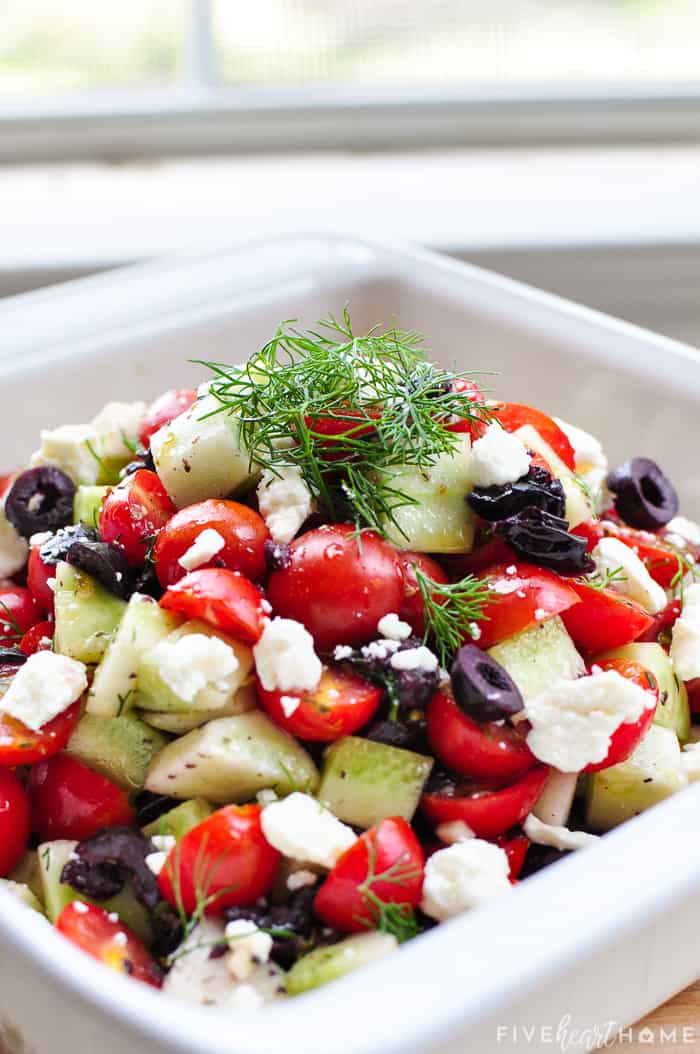 Recipe featuring black olives and dill in a serving bowl