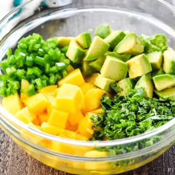 Mango Salsa ~ a fresh, simple recipe bursting with loads of summer flavor from sweet mango, creamy avocado, zesty jalapeño, and zippy cilantro...perfect as a dip or over fish! | FiveHeartHome.com