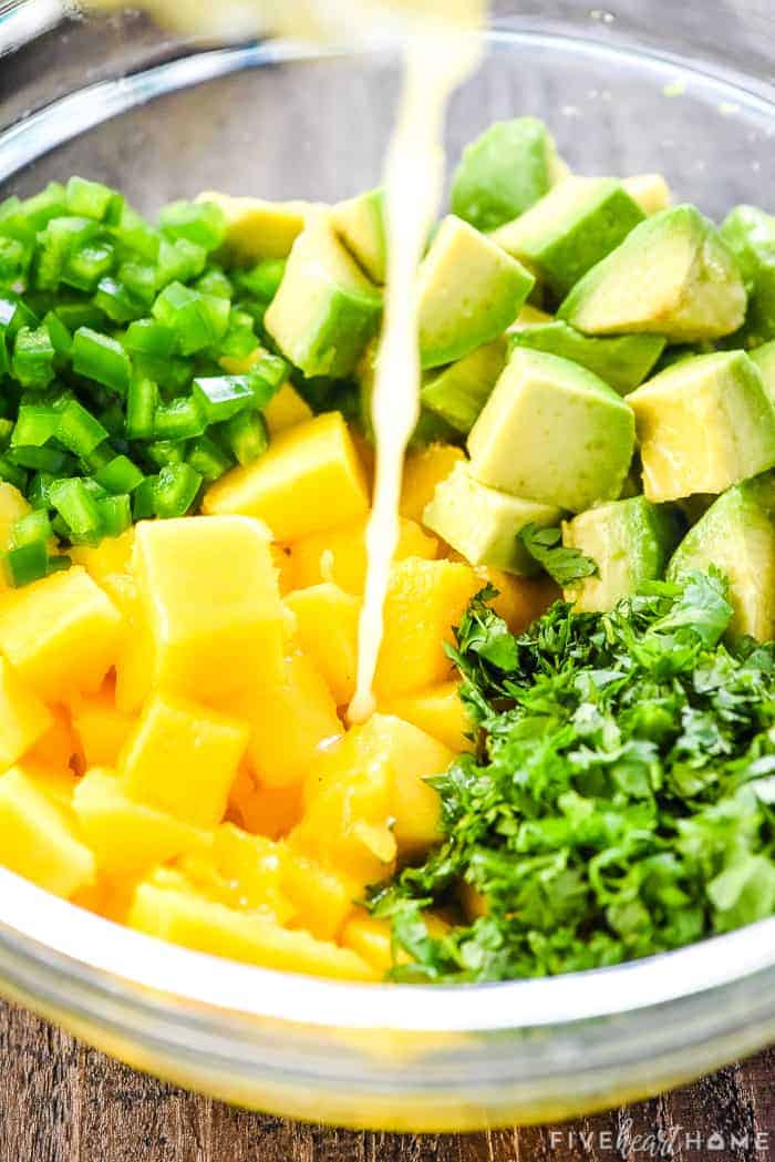 Adding lime juice to bowl.