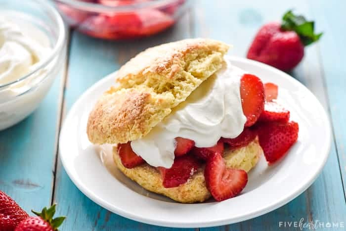 Homemade Strawberry Shortcake assembled on a plate with berries and cream.