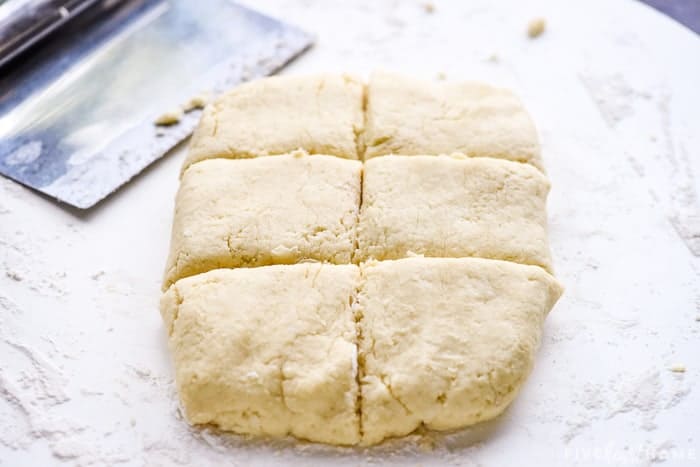 Shortcake dough cut into six squares.