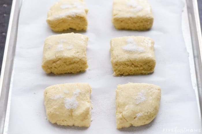 Unbaked shortcake dough squares on pan.