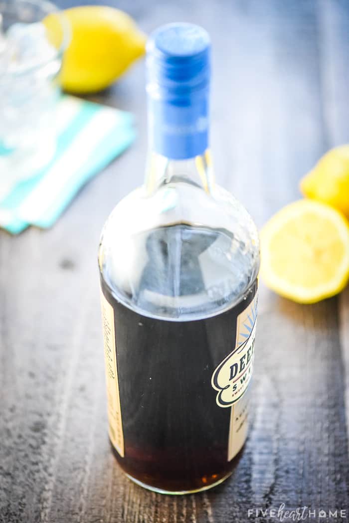 Bottle of sweet tea vodka with lemons in background.