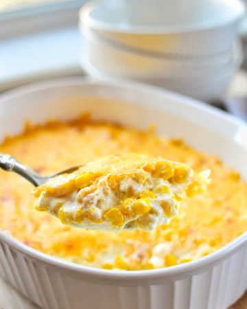 Cream Cheese Corn Casserole being scooped from serving dish.