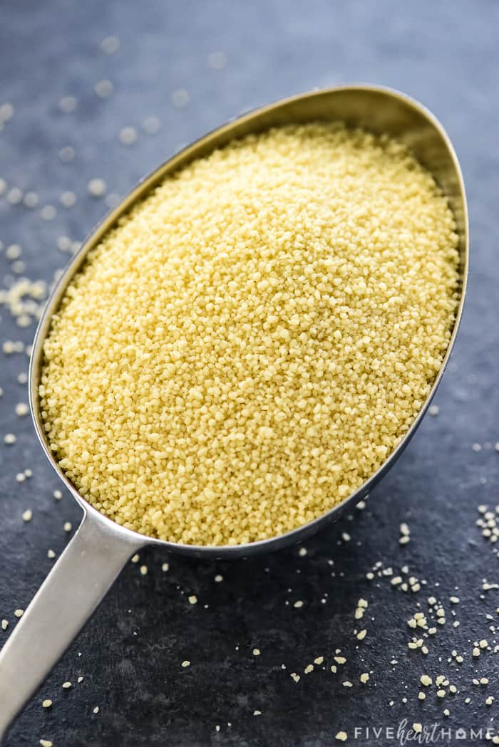 Uncooked couscous in measuring scoop