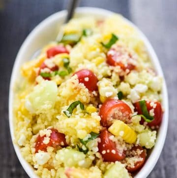 Summer Couscous Salad ~ a flavorful side dish featuring fluffy couscous studded with fresh corn, juicy tomatoes, crisp cucumbers, sweet peaches, chopped basil, and creamy feta in a honey lime dressing! | FiveHeartHome.com #couscous #couscoussalad #couscousrecipe #summersalad