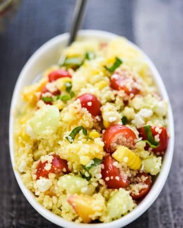 Summer Couscous Salad ~ a flavorful side dish featuring fluffy couscous studded with fresh corn, juicy tomatoes, crisp cucumbers, sweet peaches, chopped basil, and creamy feta in a honey lime dressing! | FiveHeartHome.com #couscous #couscoussalad #couscousrecipe #summersalad