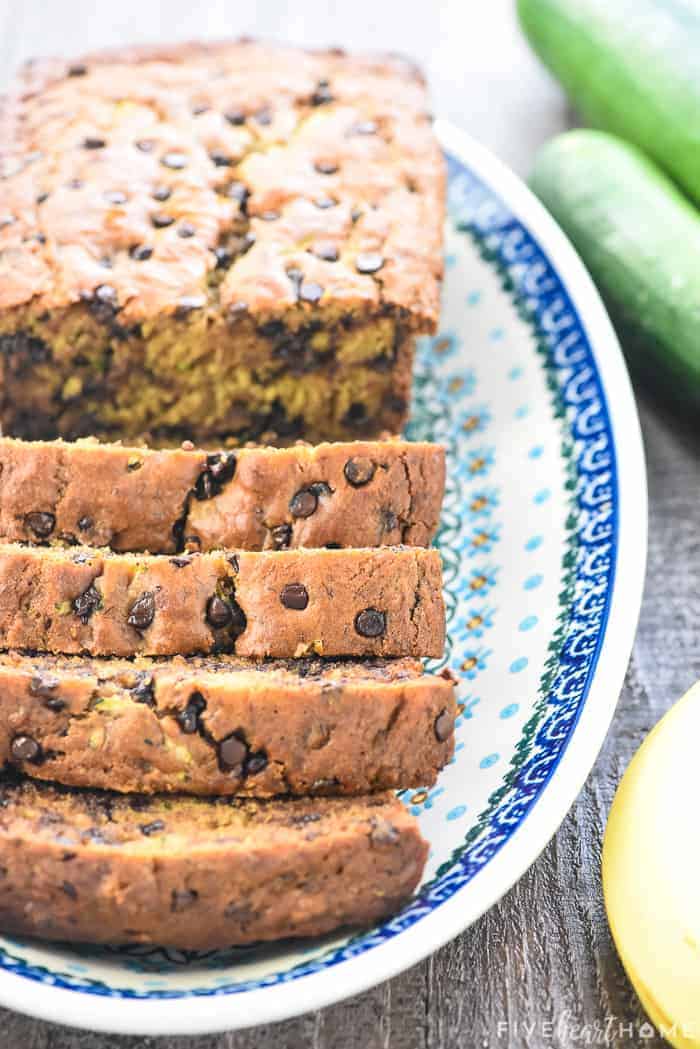 Zucchini Banana Bread sliced and on a blue and white platter