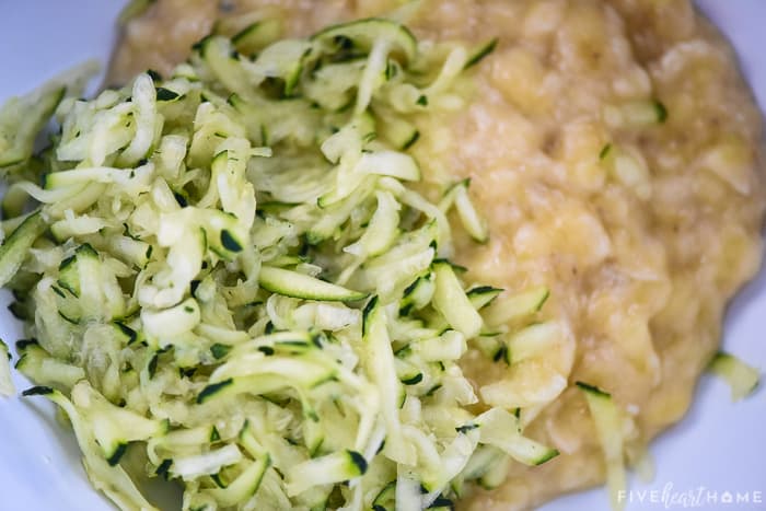 Shredded zucchini and mashed banana in a bowl