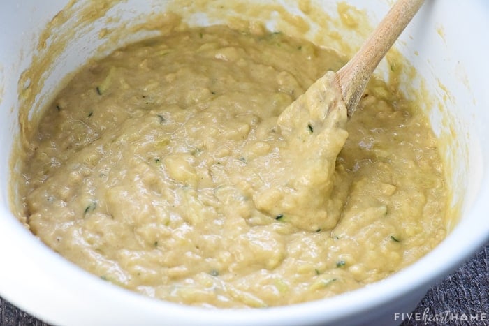 Batter being mixed in a bowl with a wooden spoon