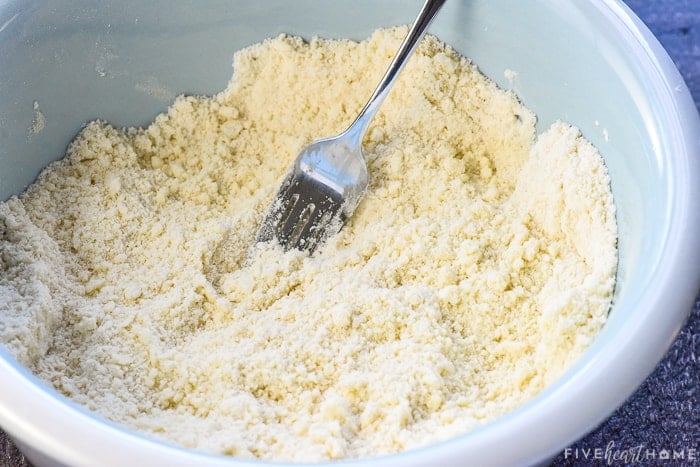 Cutting butter into flour with a fork.