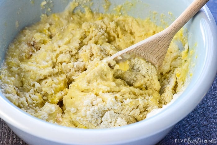 Plain muffin recipe batter stirred together with wooden spoon.