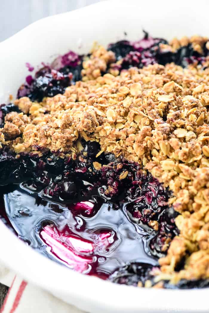 Blueberry Crisp recipe with missing scoop from baking dish.