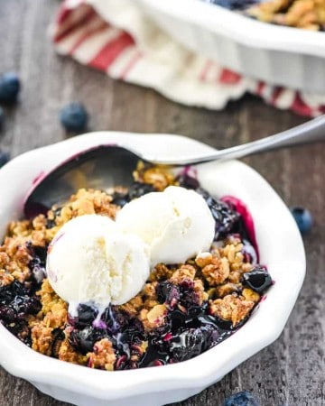Blueberry Crisp ~ this quick, easy, amazing dessert recipe boasts sweet and syrupy blueberries with a crunchy golden oat topping...and it's even better served warm with a scoop of vanilla ice cream on top! | FiveHeartHome.com #blueberrycrisp