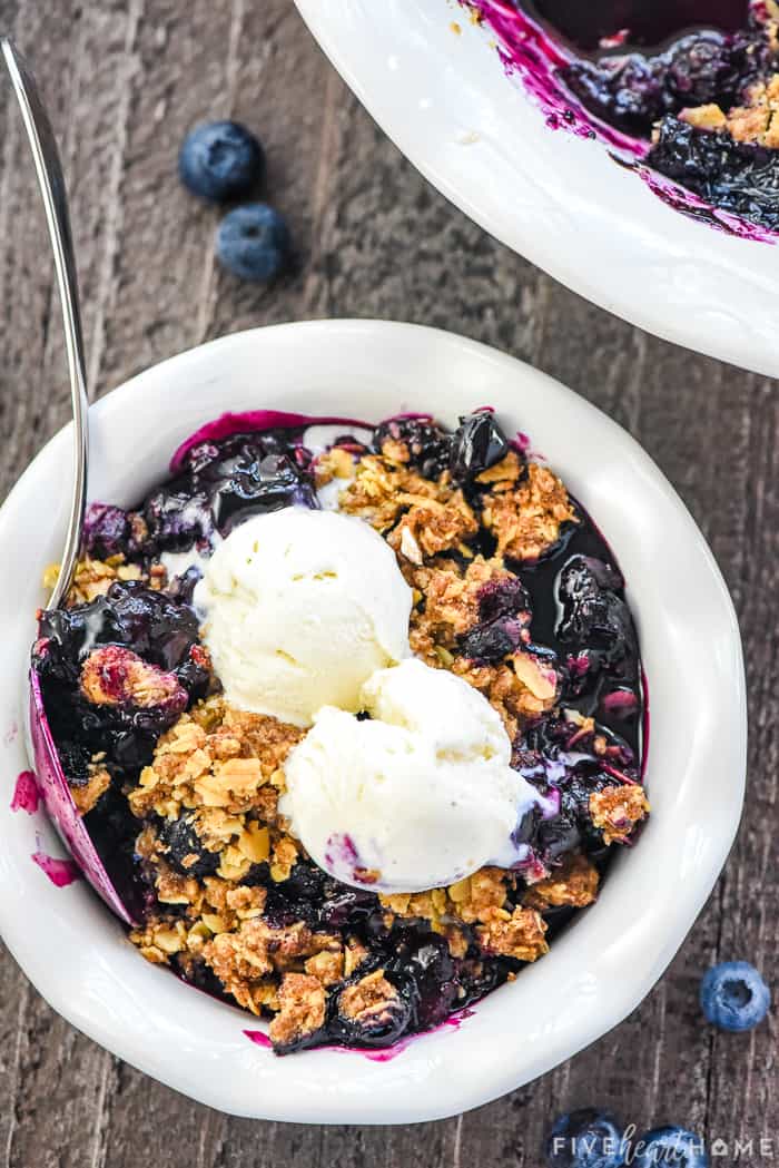 Blueberry Crisp in a bowl with ice cream on top.