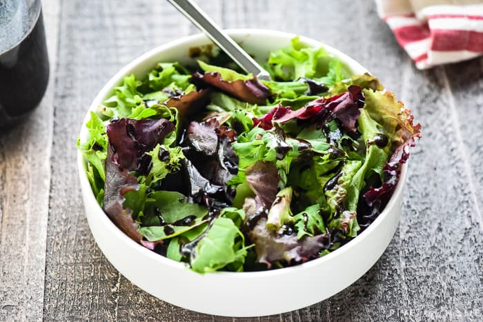 Balsamic dressing drizzled over salad.