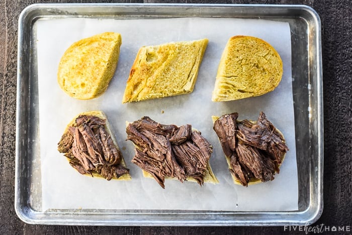 Slow Cooker French Dip ~ this crock pot recipe features succulent beef slow cooked in a flavorful broth, served on toasty rolls with melted cheese and extra au jus for dipping! | FiveHeartHome.com