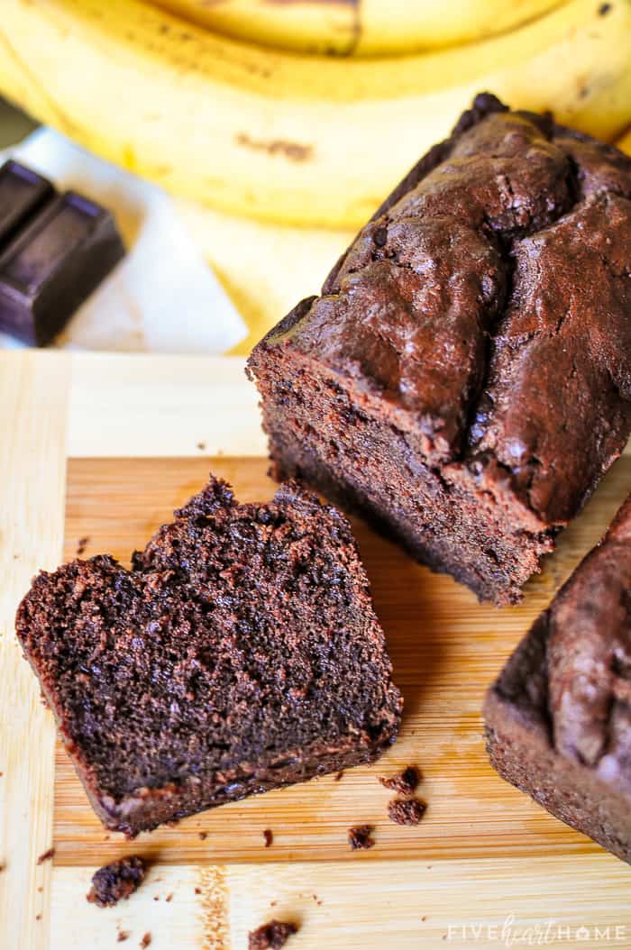 Triple Chocolate Banana Bread ~ moist, fudgy, and loaded with three kinds of chocolate, making this banana bread recipe a mouthwatering, delicious way to use up overripe bananas! | FiveHeartHome.com Aerial view of slice on cutting board