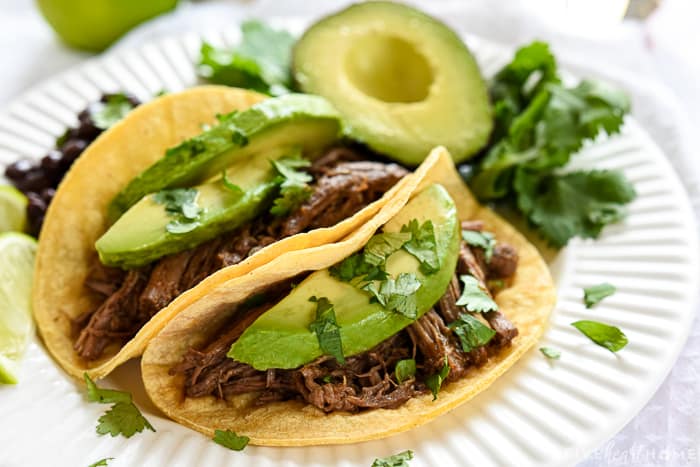 Slow Cooker Barbacoa ~ a delicious addition to tacos, burritos, rice bowls, salads, and more...and this easy, succulent, crockpot version is bursting with chipotles, garlic, cilantro, & Mexican spices! | FiveHeartHome.com #barbacoa #tacos #tacotuesday #barbacoabeef