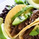 Slow Cooker Barbacoa ~ a delicious addition to tacos, burritos, rice bowls, salads, and more...and this easy, succulent, crockpot version is bursting with chipotles, garlic, cilantro, & Mexican spices! | FiveHeartHome.com