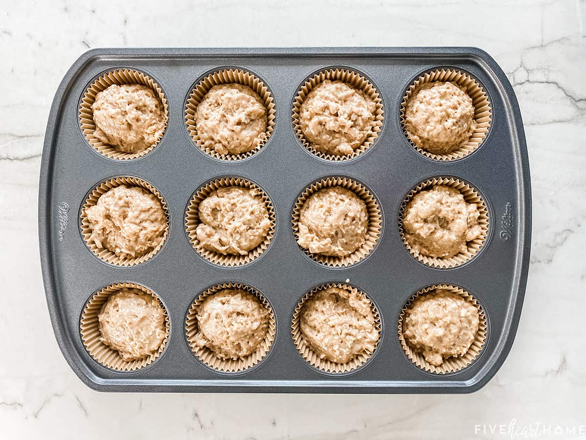 Aerial view of muffin pan with oatmeal muffin recipe batter.