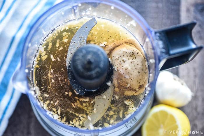 Aerial view of dressing ingredients in mini food processor.