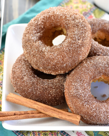 Baked Apple Cider Donuts piled on plate.
