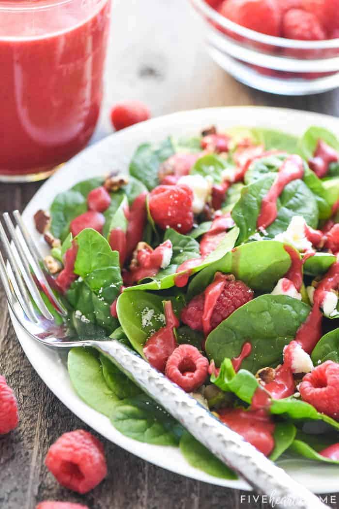 Green salad topped with raspberries, nuts, feta, and Raspberry Vinaigrette.