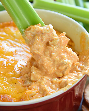 Chicken Wing Dip being scooped up by celery.