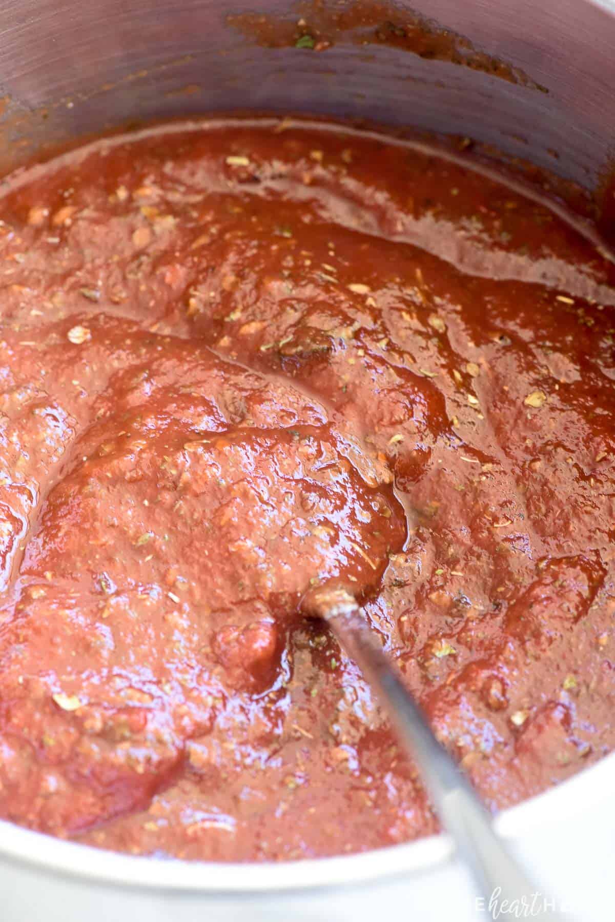 Best Pizza Sauce being stirred together in pot.