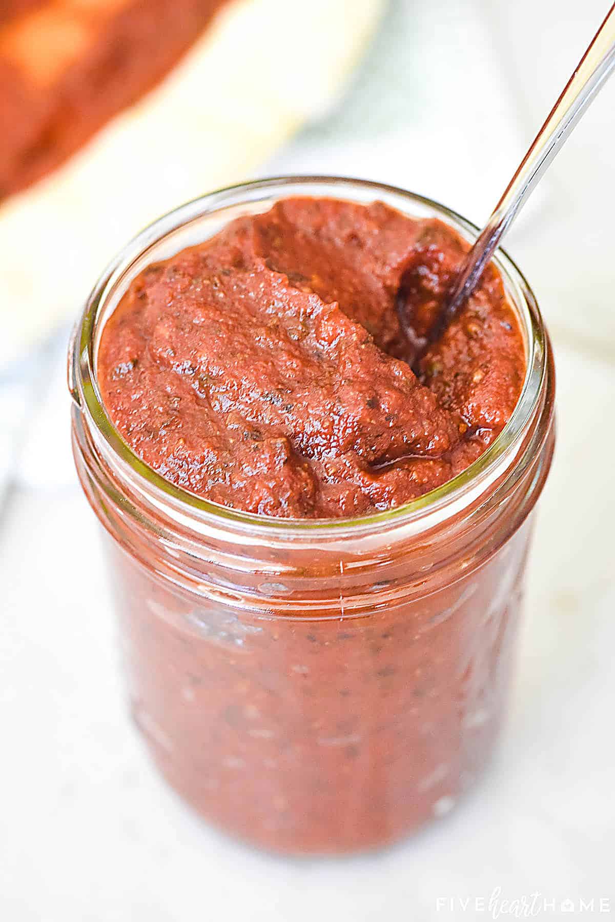 Jar of homemade Best Pizza Sauce with spoon.