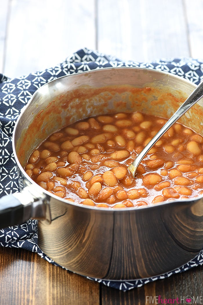 Quick Stovetop Baked Beans in a pot with a spoon.