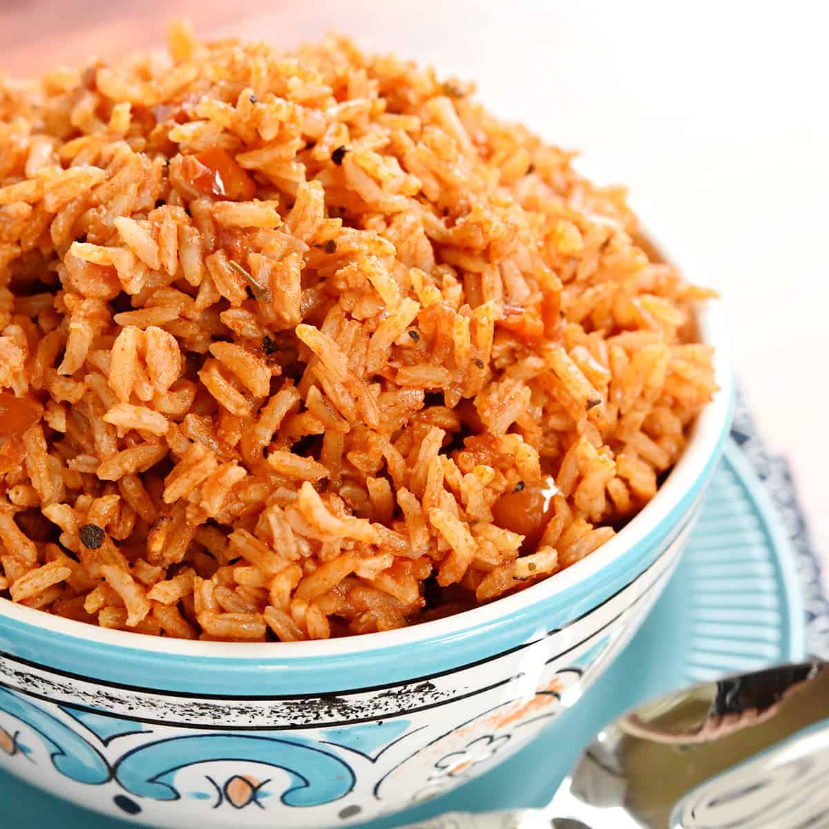 Spanish Rice piled up in blue and white serving bowl.