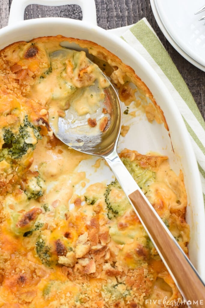 Aerial view of Broccoli Cheese Casserole with scoop missing.