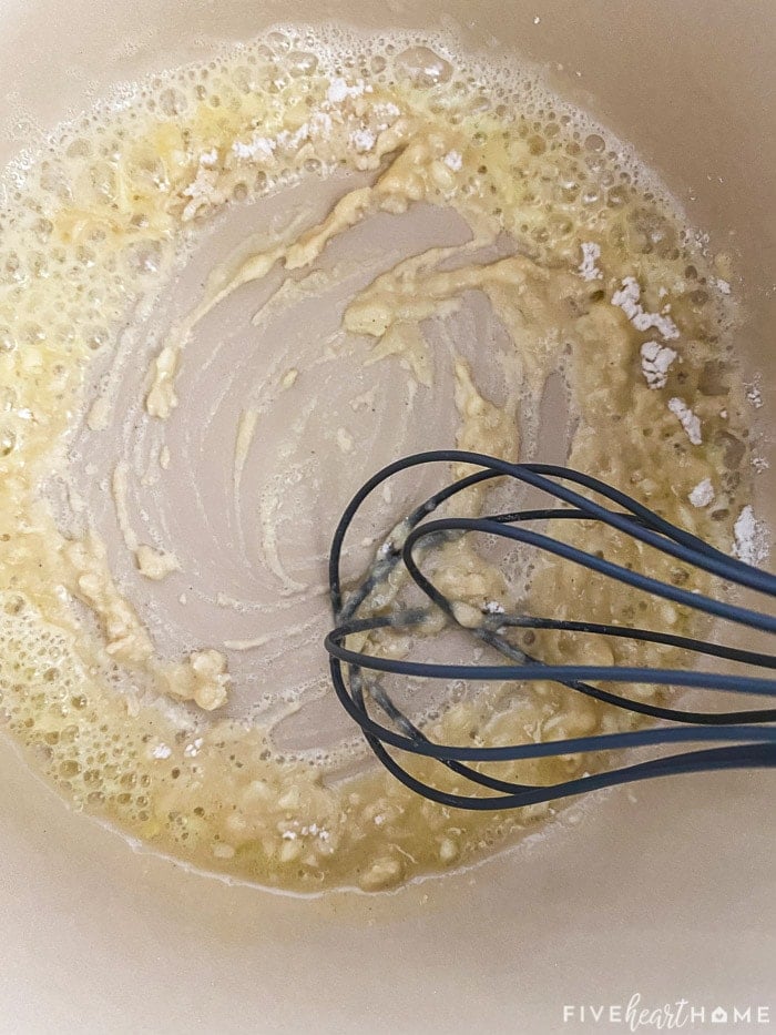 Flour being whisked in.