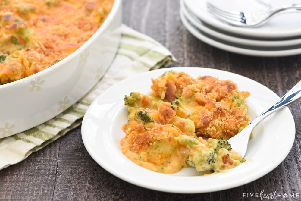 Broccoli Cheese Casserole on plate and in dish with stack of plates.