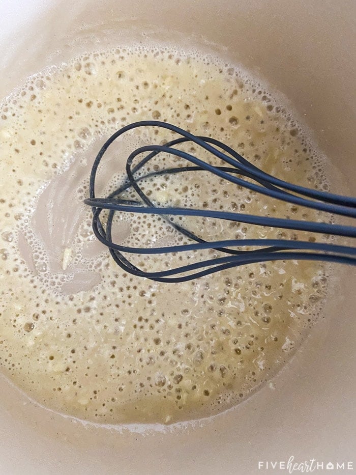 Flour, butter, and garlic whisked together in pot.