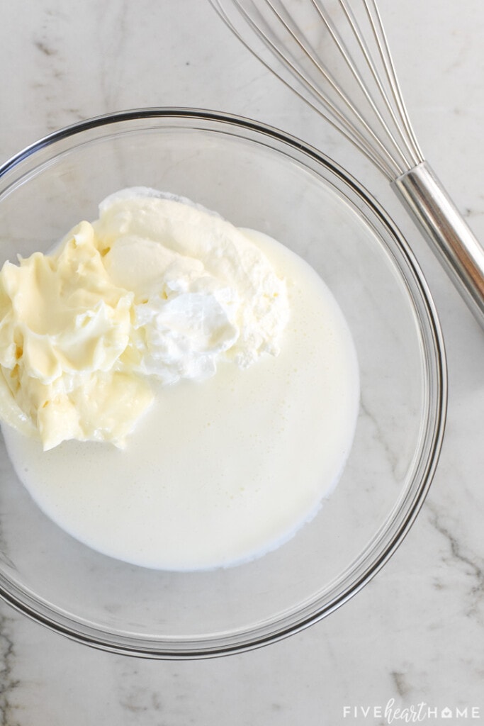 Buttermilk, mayonnaise, and sour cream in glass bowl.