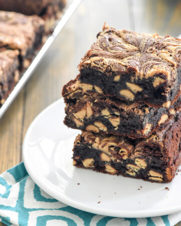 Peanut Butter Brownies stacked on a white plate.