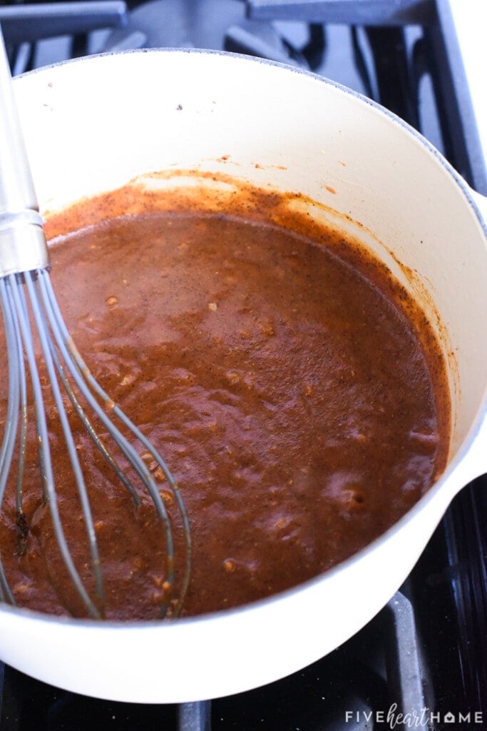 Finished sauce in pot with whisk.