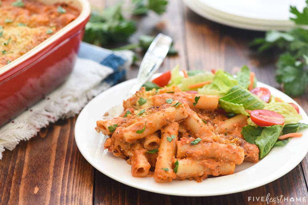 Five Cheese Ziti al Forno on plate with salad.