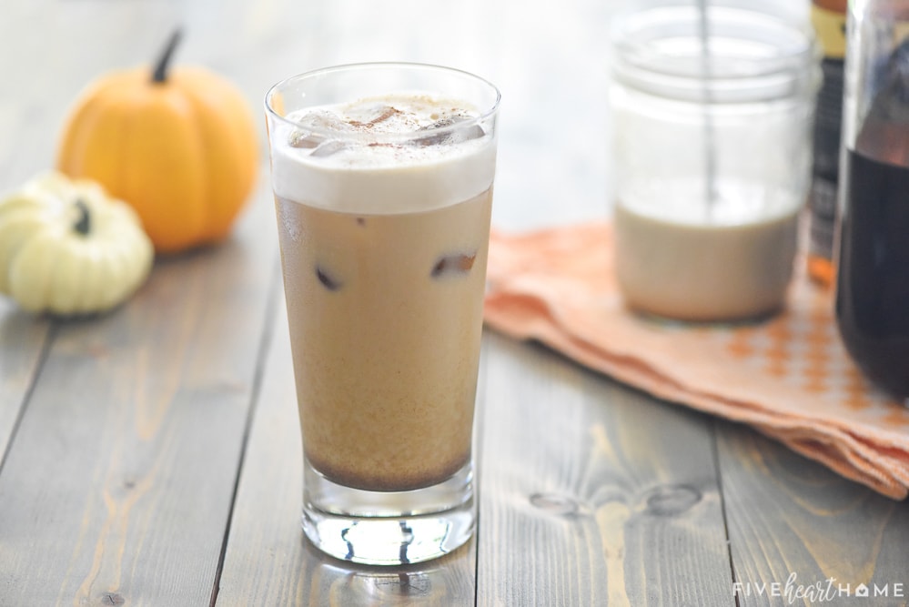 Pumpkin Cream Cold Brew in glass plus ingredients to make it in background.