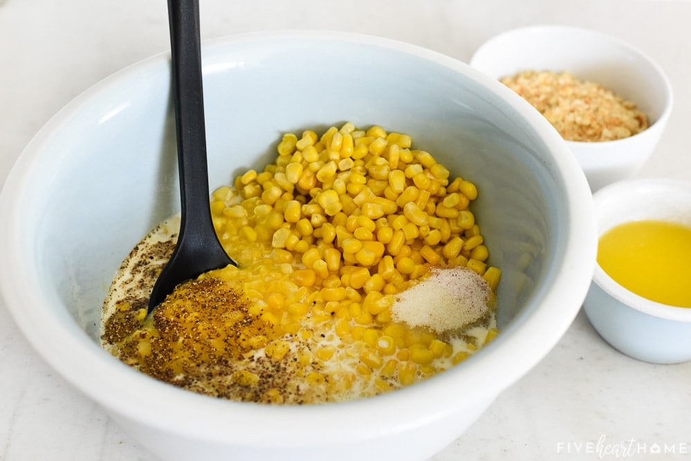 Corn and creamed corn in bowl with salt and pepper.