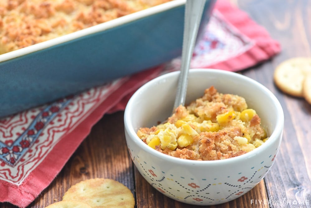 Scalloped Corn recipe in serving bowl with spoon.