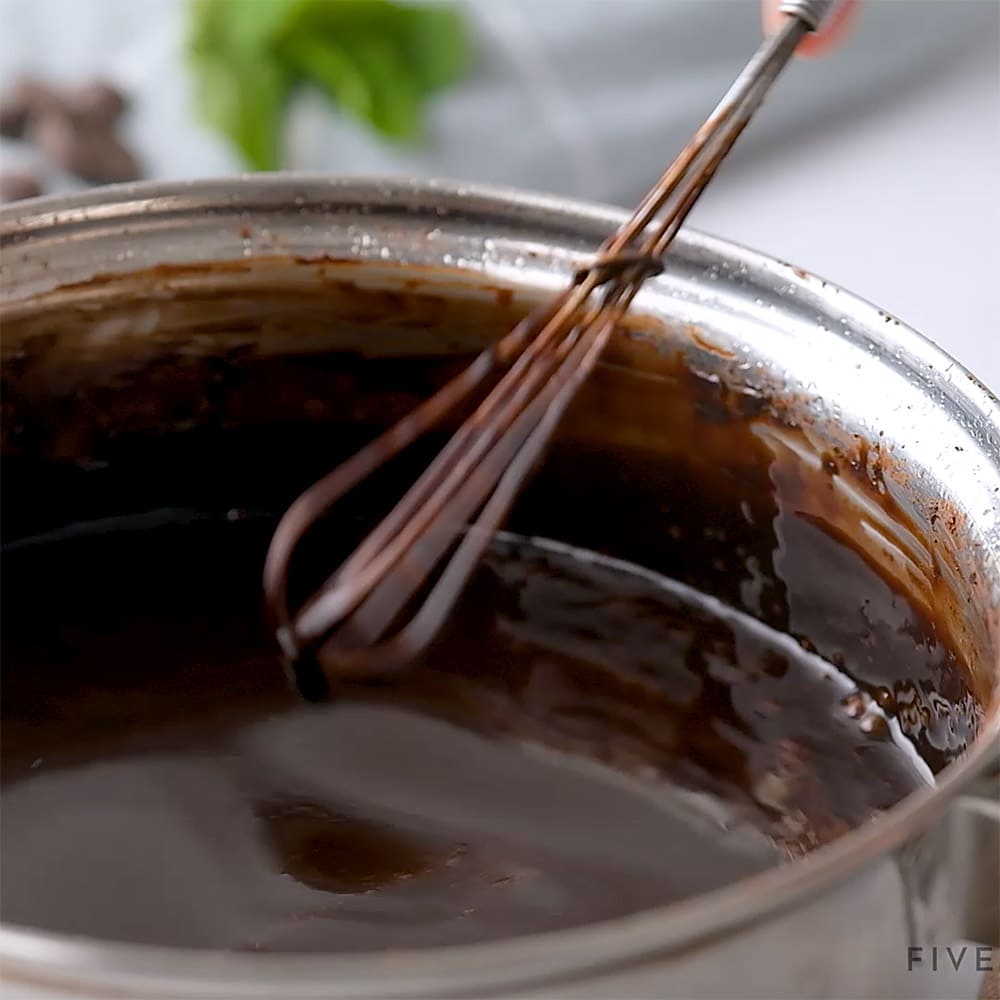 Close-up of whisk stirring pot.